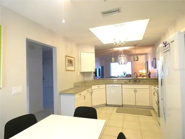 a kitchen with stainless steel appliances kitchen island granite countertop a sink and cabinets