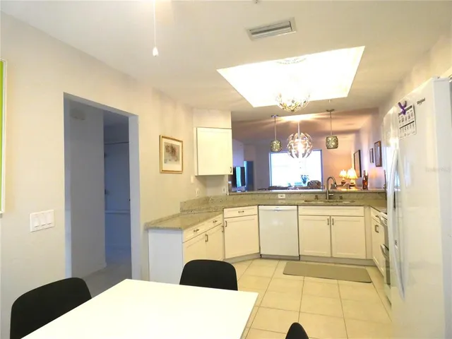 a kitchen with stainless steel appliances kitchen island granite countertop a sink and cabinets
