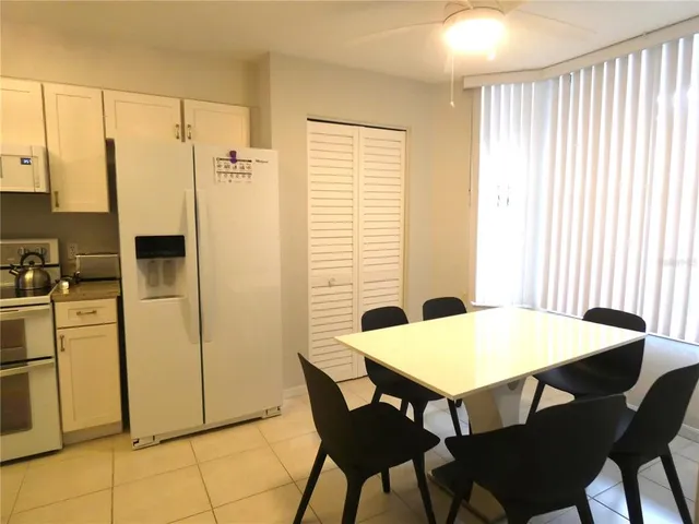a view of a dining room with furniture and a window