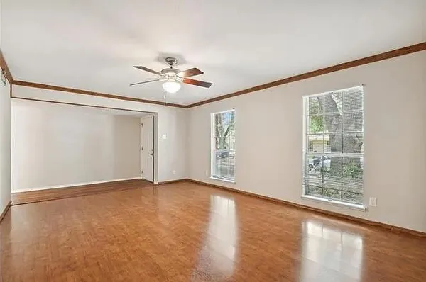 wooden floor in an empty room with a window