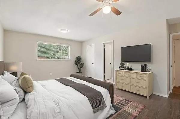 a bedroom with a bed and a flat screen tv