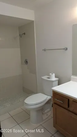 a white toilet sitting next to a bathroom sink