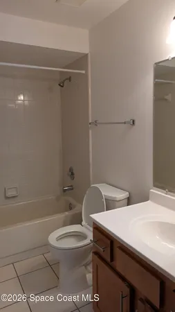 a bathroom with a toilet a sink and shower