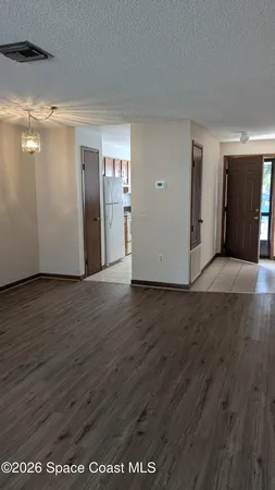 a view of a kitchen with wooden floor