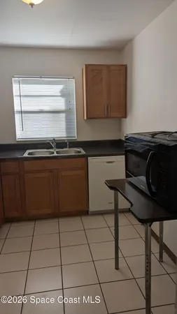a kitchen with a cabinets a stove a sink and a counter top space