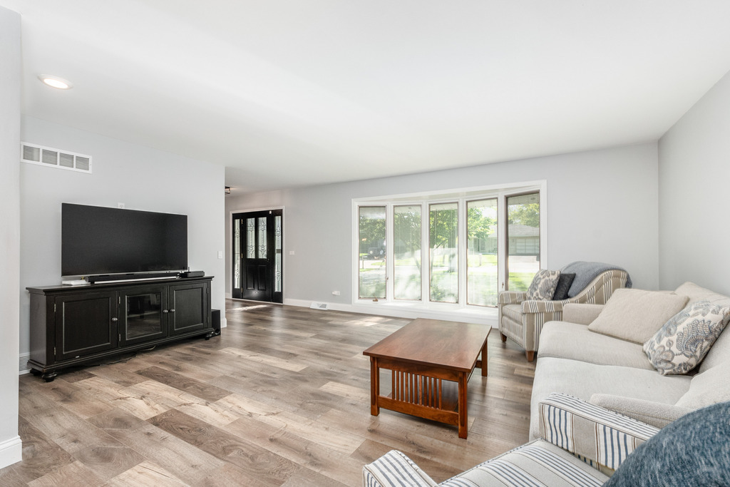 1570 Burning Trail Wheaton, IL 60189 - Photo 12 of 30 a living room with furniture a flat screen tv and a refrigerator