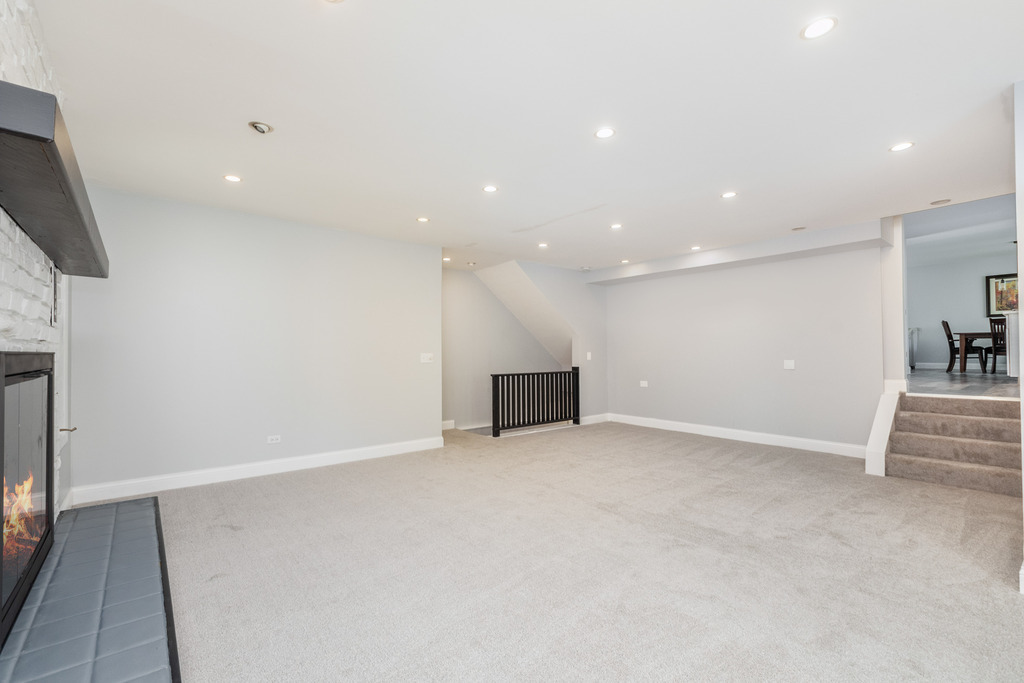 1570 Burning Trail Wheaton, IL 60189 - Photo 16 of 30 an empty room with wooden floor and a fireplace