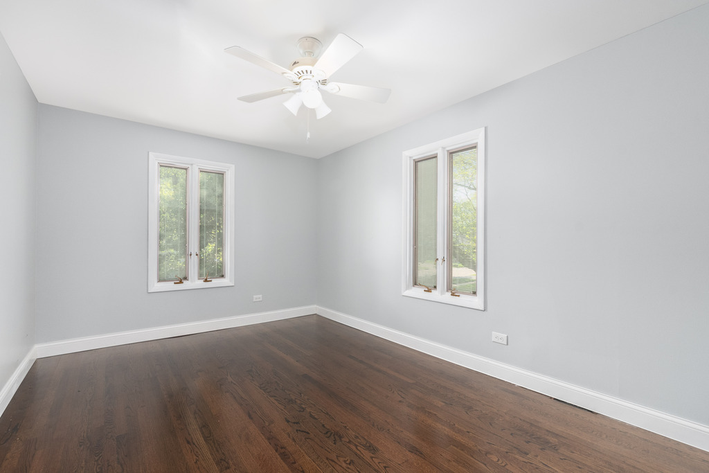 1570 Burning Trail Wheaton, IL 60189 - Photo 21 of 30 a view of an empty room with wooden floor and a window