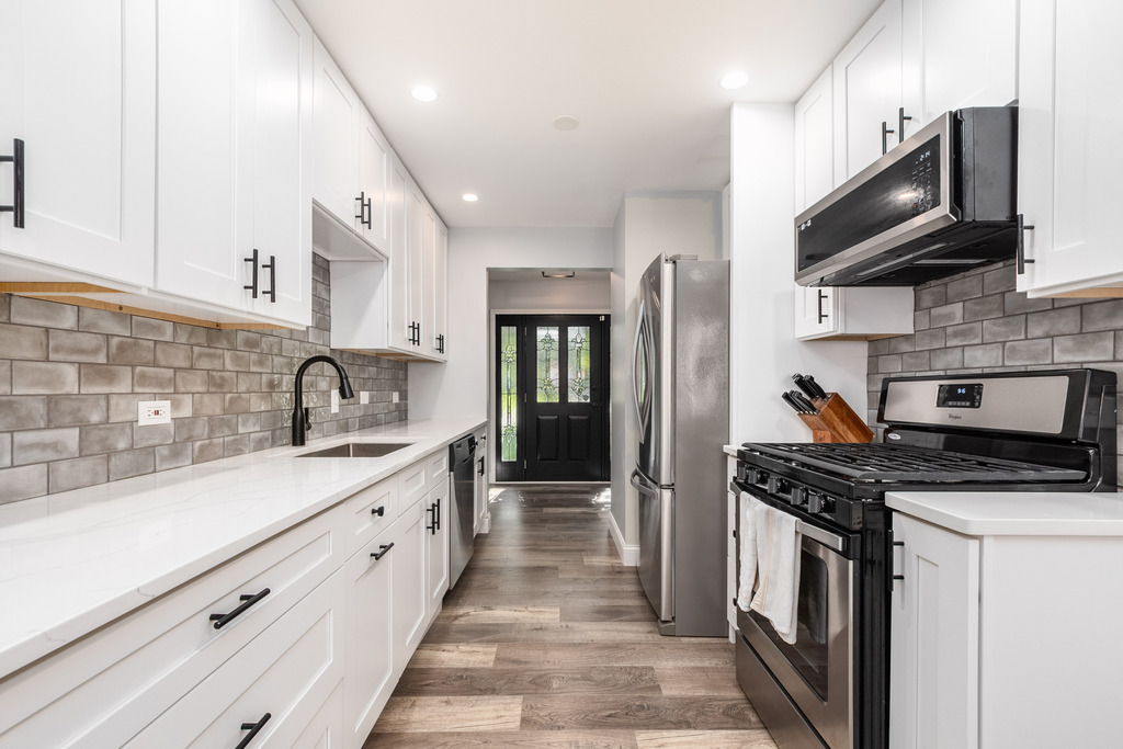1570 Burning Trail Wheaton, IL 60189 - Photo 6 of 30 a kitchen with stainless steel appliances granite countertop a stove a sink and a microwave