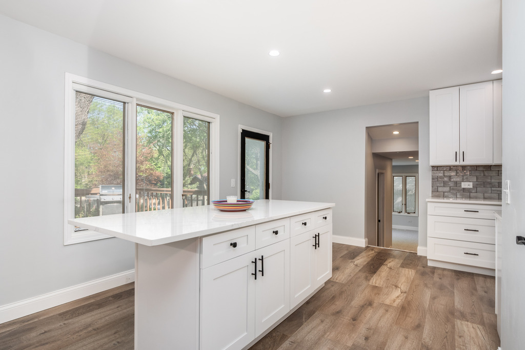 1570 Burning Trail Wheaton, IL 60189 - Photo 8 of 30 a kitchen with white cabinets and wooden floors