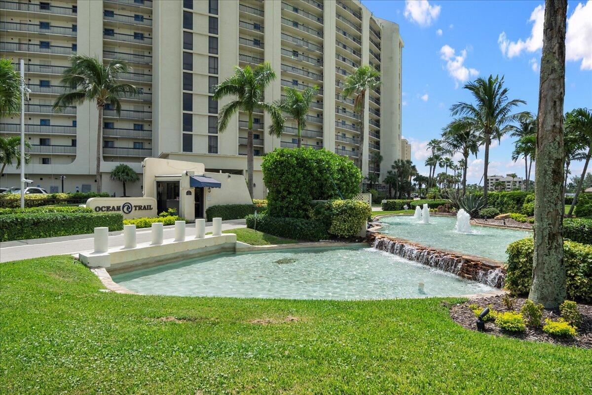 200 Ocean Trail Way, Unit 1105 Jupiter, FL 33477 - Photo 15 of 35 a front view of a residential apartment building with a yard