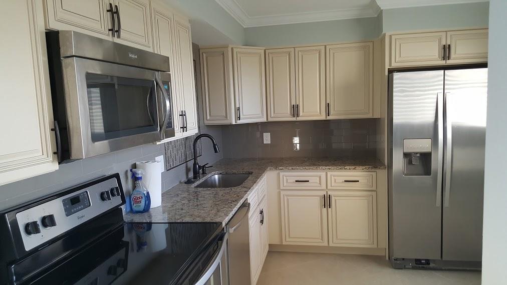 200 Ocean Trail Way, Unit 1105 Jupiter, FL 33477 - Photo 2 of 35 a kitchen with stainless steel appliances granite countertop a sink a stove and a refrigerator