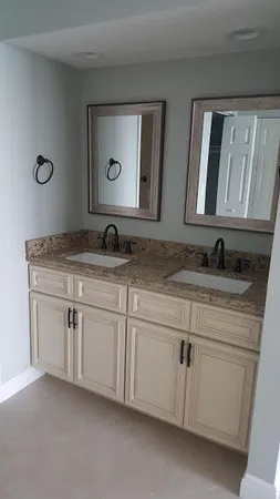 a bathroom with double sink and a mirror