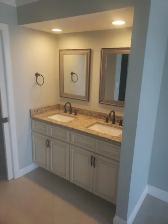 a bathroom with 2 sink and a mirror