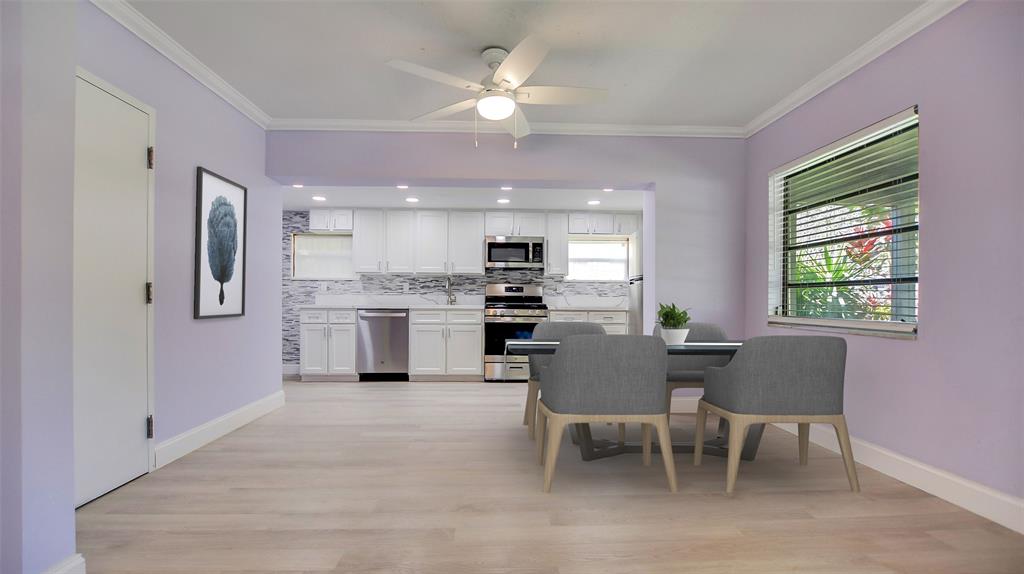 600 Southwest 19th Street Fort Lauderdale, FL 33315 - Photo 5 of 24 a kitchen with kitchen island a dining table chairs stainless steel appliances cabinets and a window