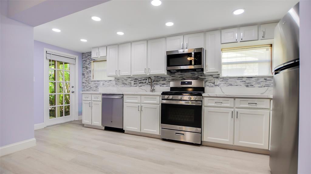 600 Southwest 19th Street Fort Lauderdale, FL 33315 - Photo 6 of 24 a kitchen with stainless steel appliances granite countertop a stove a sink and a refrigerator