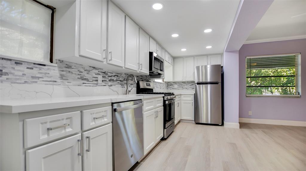 600 Southwest 19th Street Fort Lauderdale, FL 33315 - Photo 7 of 24 a kitchen with stainless steel appliances granite countertop a refrigerator sink and cabinets