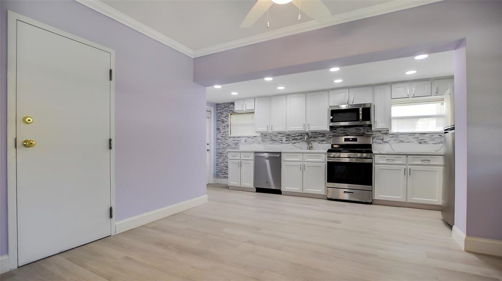 600 Southwest 19th Street Fort Lauderdale, FL 33315 - Photo 8 of 24 a kitchen with granite countertop white cabinets and stainless steel appliances
