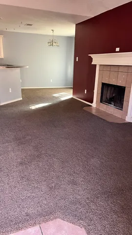 a view of empty room with a fireplace