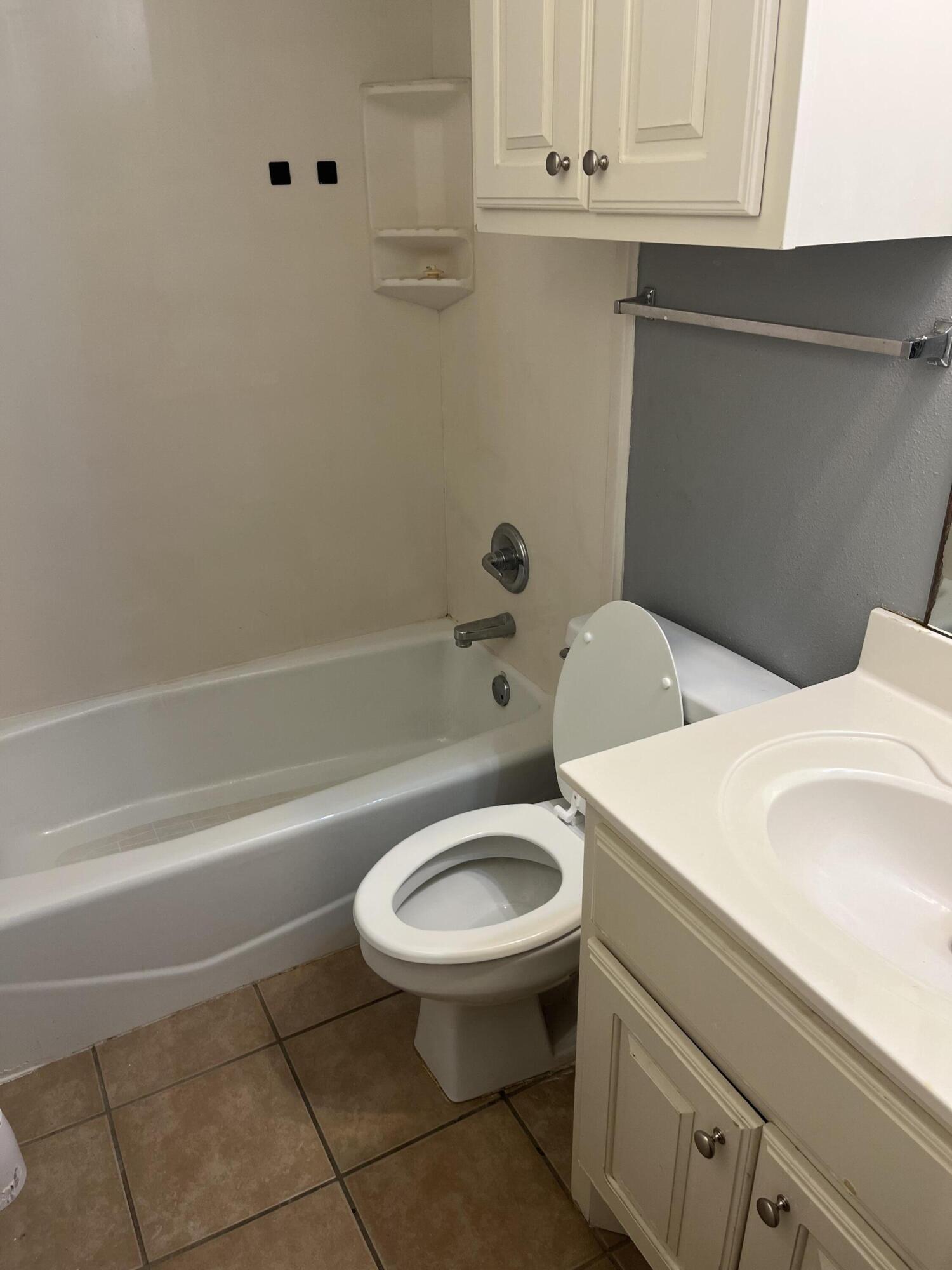 3102 110th Street, Unit B Lubbock, TX 79423 - Photo 8 of 8 a bathroom with a sink a toilet and bathtub