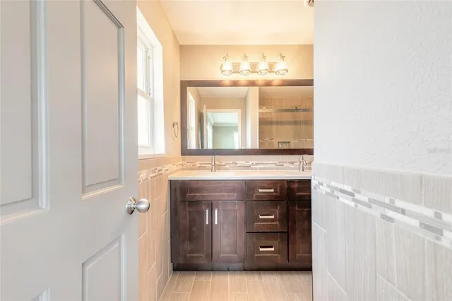 a bathroom with a sink and a window