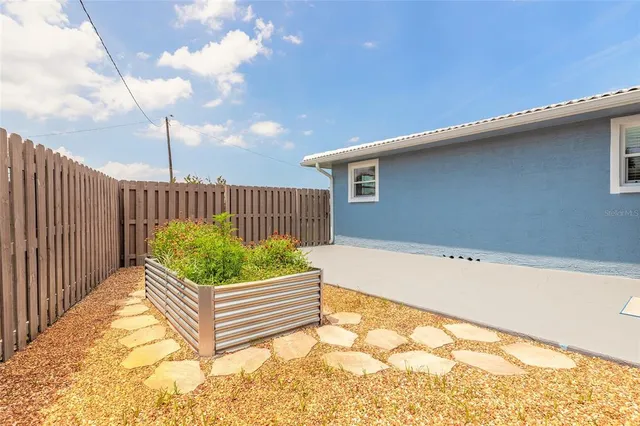 a view of a backyard with a wooden fence