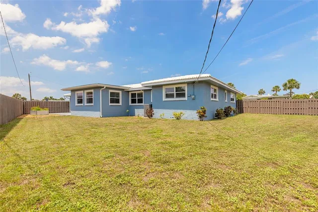 a blue swimming pool is next to a building