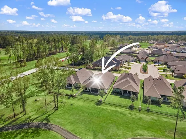 a living room with furniture and large windows