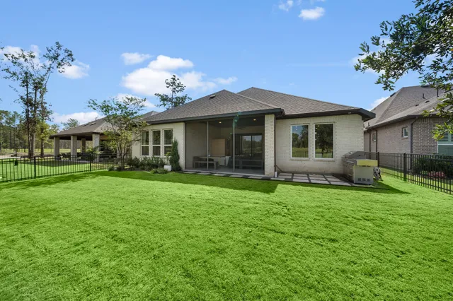 a view of a house with a yard and sitting area