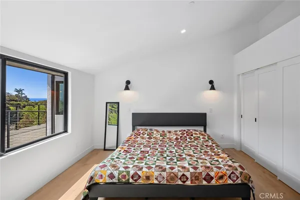 a bed sitting in a bedroom next to a window