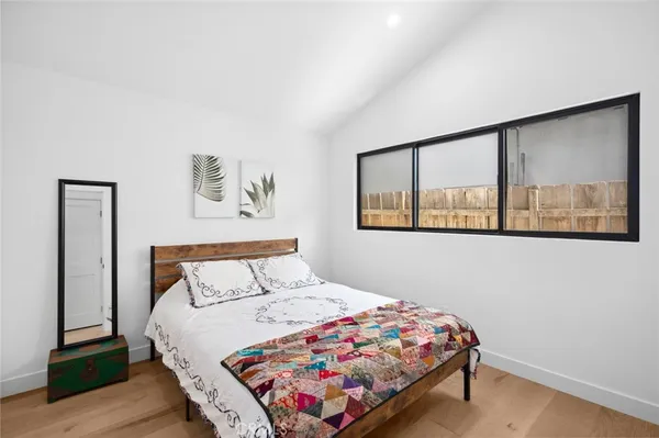 a bedroom with a bed and a painting on the wall