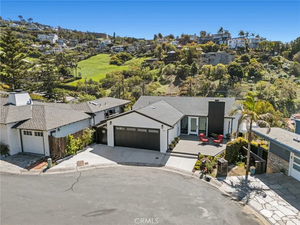 an aerial view of a house with a yard sitting area and a garage