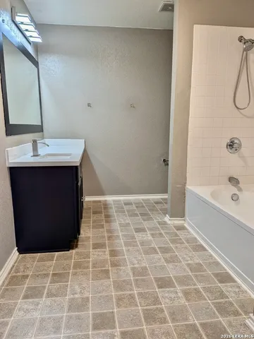 a bathroom with a bathtub and a sink