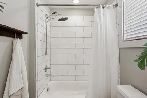 a bedroom with a bed and flat screen tv