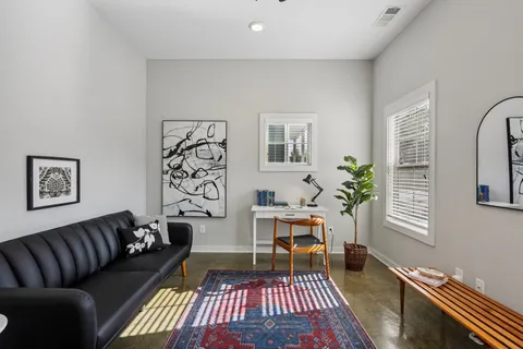 a living room with furniture and wooden floor