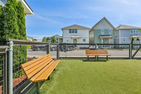 a view of a house with a wooden deck and a yard