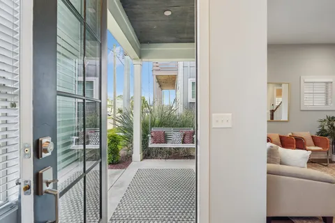 a kitchen with stainless steel appliances granite countertop a stove top oven a sink dishwasher a dining table and chairs with wooden floor