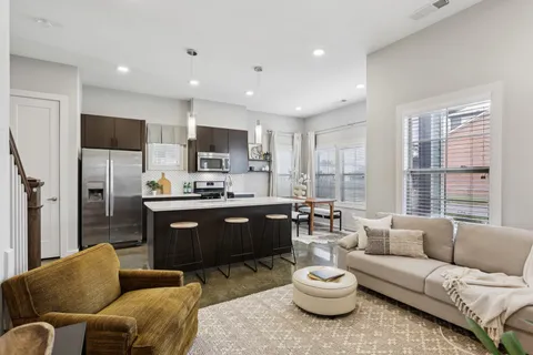 a living room with furniture and wooden floor