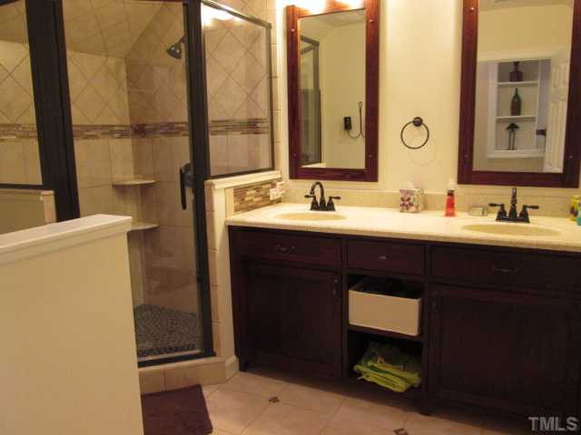 8120 Standing Stone Court Raleigh, NC 27613 - Photo 20 of 25 Wonderful secondary bath in bonus room makes the bonus a perfect place for another bedroom! This great bathroom features shower with custom tile work, double sink vanity, tiled flooring, shower is all tiled with river stone flooring! Bathroom