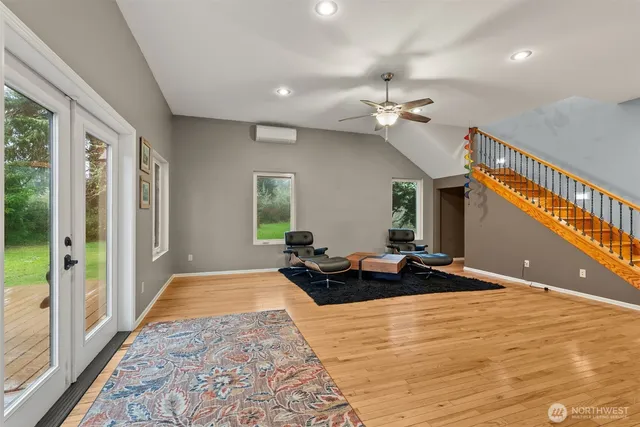 a bedroom with bed and wooden floor
