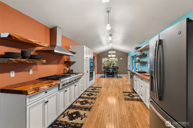 a kitchen with stainless steel appliances lots of counter space and wooden floor