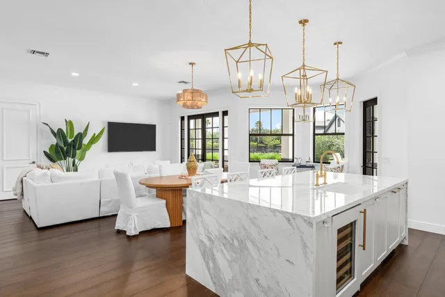 a view of a dining room with furniture wooden floor and chandelier