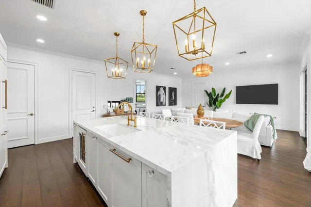 a kitchen with white cabinets and appliances