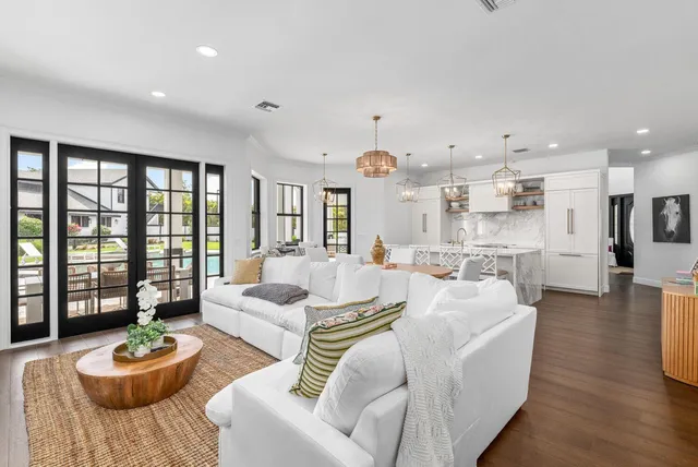 a view of a dining room with furniture wooden floor and chandelier