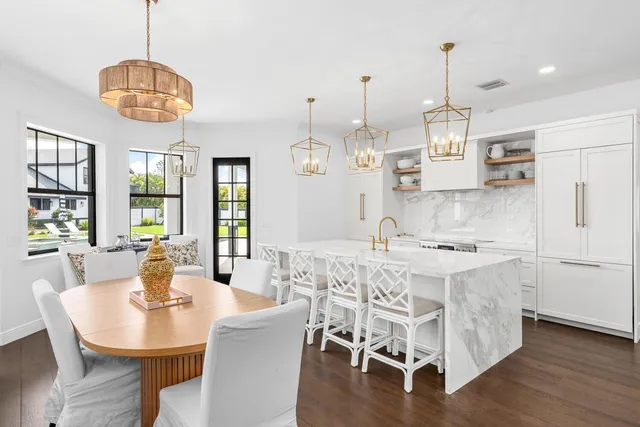 a living room with furniture a mirror and wooden floor