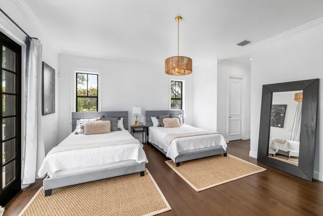 a bath room with a sink double vanity granite tub and a mirror