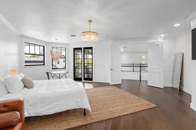 a spacious bathroom with double vanity sink a mirror a bathtub and window