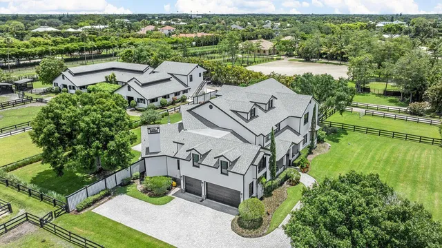 an aerial view of a house with garden space and street view
