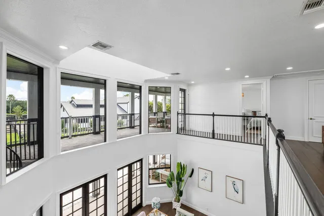 a balcony with furniture and a floor to ceiling window