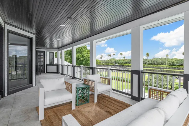 a swimming pool with outdoor seating and trees